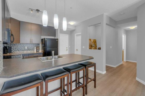 207-207 Sunset Drive, Cochrane, AB - Indoor Photo Showing Kitchen With Double Sink