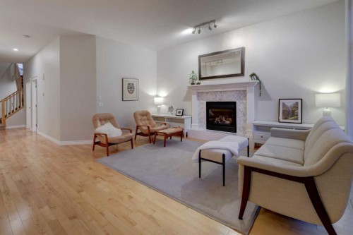 57 Discovery Ridge Hill Sw, Calgary, AB - Indoor Photo Showing Living Room With Fireplace