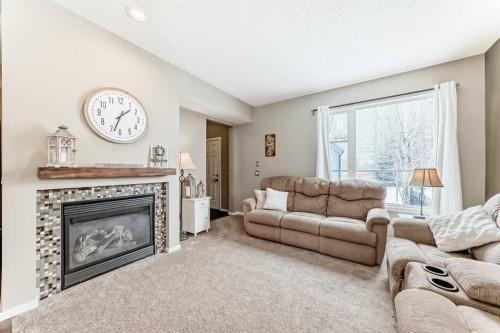 63 Chapalina Square Se, Calgary, AB - Indoor Photo Showing Living Room With Fireplace