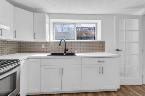 10 Radcliffe Crescent Se, Calgary, AB - Indoor Photo Showing Kitchen With Double Sink