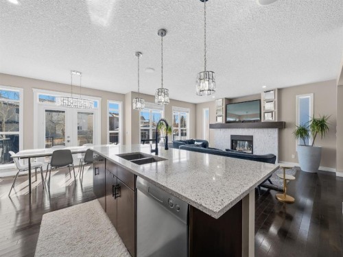 91 Silverado Ridge Crescent Sw, Calgary, AB - Indoor Photo Showing Kitchen With Fireplace With Double Sink With Upgraded Kitchen