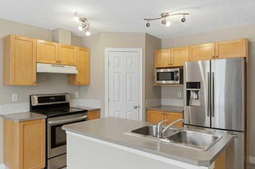 99 Covepark Square Ne, Calgary, AB - Indoor Photo Showing Kitchen With Stainless Steel Kitchen With Double Sink