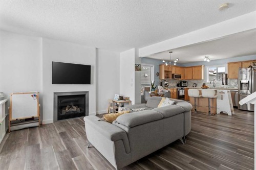 219 Silverado Plains Close Sw, Calgary, AB - Indoor Photo Showing Living Room With Fireplace