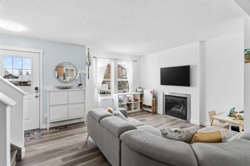 219 Silverado Plains Close Sw, Calgary, AB - Indoor Photo Showing Living Room With Fireplace