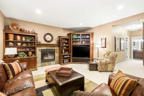 21 Evergreen Row Sw, Calgary, AB - Indoor Photo Showing Living Room With Fireplace
