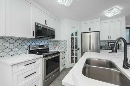 8430 Saddleridge Drive Ne, Calgary, AB - Indoor Photo Showing Kitchen With Stainless Steel Kitchen With Double Sink With Upgraded Kitchen