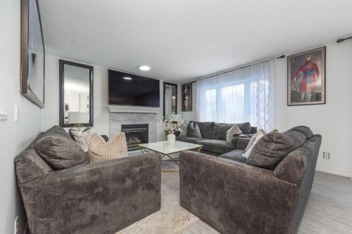 8430 Saddleridge Drive Ne, Calgary, AB - Indoor Photo Showing Living Room With Fireplace
