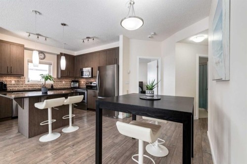121-402 Marquis Lane Se, Calgary, AB - Indoor Photo Showing Kitchen With Stainless Steel Kitchen With Upgraded Kitchen