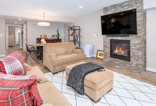 103-810 7Th Street, Canmore, AB - Indoor Photo Showing Living Room With Fireplace