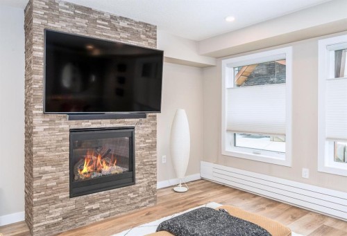 103-810 7Th Street, Canmore, AB - Indoor Photo Showing Living Room With Fireplace