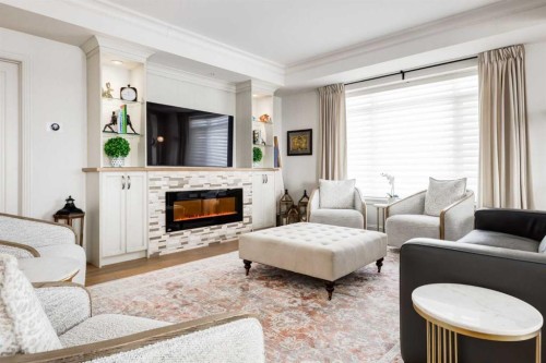 306-131 Quarry Way Se, Calgary, AB - Indoor Photo Showing Living Room With Fireplace