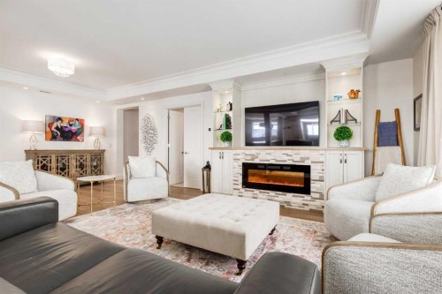 306-131 Quarry Way Se, Calgary, AB - Indoor Photo Showing Living Room With Fireplace