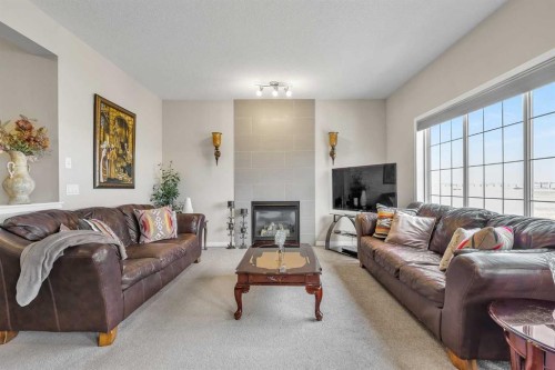 87 Panton Landing Nw, Calgary, AB - Indoor Photo Showing Living Room With Fireplace