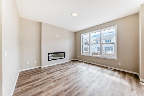 1085 Sawgrass Link Nw, Airdrie, AB - Indoor Photo Showing Other Room With Fireplace