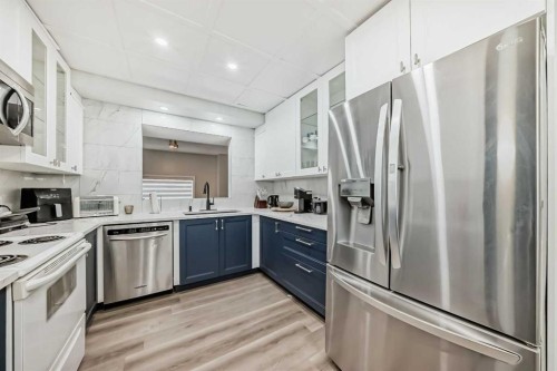 2-7 Westland Road, Okotoks, AB - Indoor Photo Showing Kitchen With Stainless Steel Kitchen