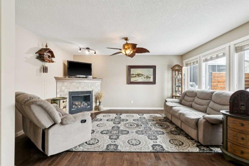 23 Kingston View Se, Airdrie, AB - Indoor Photo Showing Living Room With Fireplace
