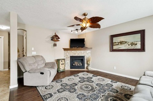 23 Kingston View Se, Airdrie, AB - Indoor Photo Showing Living Room With Fireplace