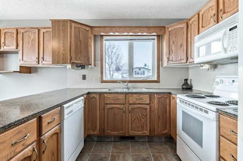 104 Macewan Meadow Way Nw, Calgary, AB - Indoor Photo Showing Kitchen With Double Sink
