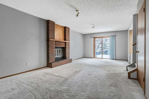 104 Macewan Meadow Way Nw, Calgary, AB - Indoor With Fireplace
