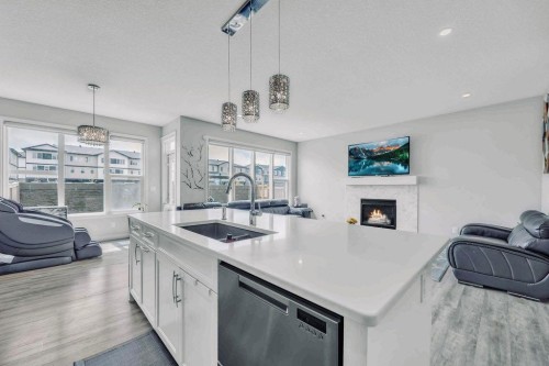 184 Cornerbrook Common Ne, Calgary, AB - Indoor Photo Showing Kitchen With Fireplace