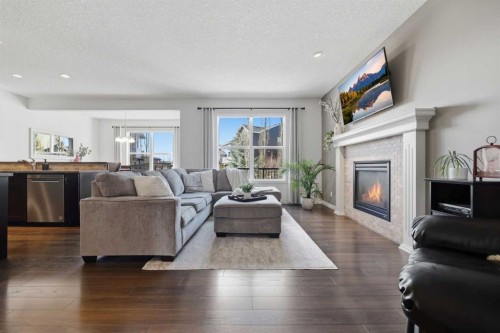 344 Sunset View, Cochrane, AB - Indoor Photo Showing Living Room With Fireplace