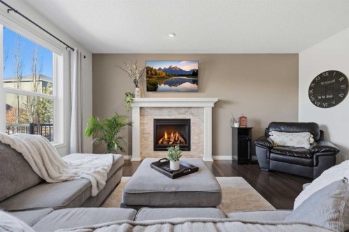 344 Sunset View, Cochrane, AB - Indoor Photo Showing Living Room With Fireplace