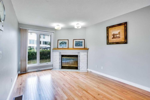219 Coachway Lane Sw, Calgary, AB - Indoor Photo Showing Living Room With Fireplace