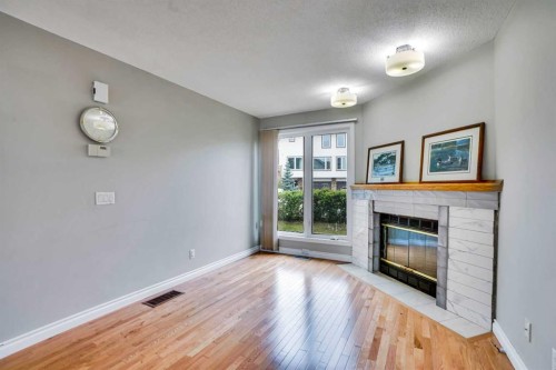 219 Coachway Lane Sw, Calgary, AB - Indoor Photo Showing Living Room With Fireplace