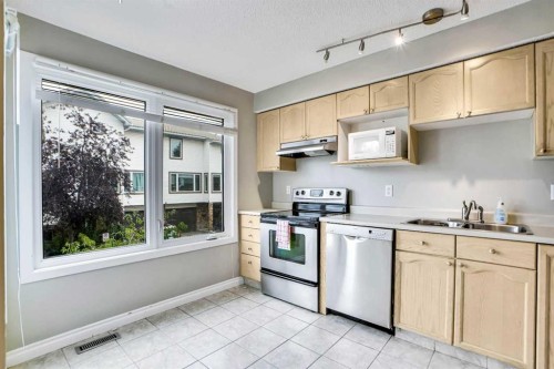 219 Coachway Lane Sw, Calgary, AB - Indoor Photo Showing Kitchen With Stainless Steel Kitchen With Double Sink