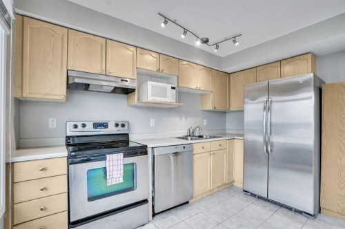 219 Coachway Lane Sw, Calgary, AB - Indoor Photo Showing Kitchen With Stainless Steel Kitchen With Double Sink