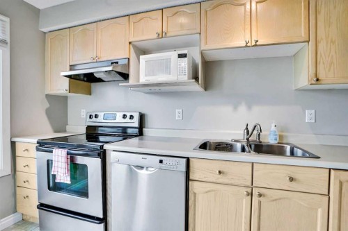 219 Coachway Lane Sw, Calgary, AB - Indoor Photo Showing Kitchen With Stainless Steel Kitchen With Double Sink