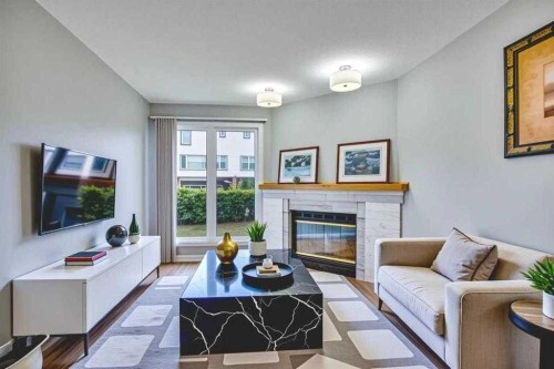 219 Coachway Lane Sw, Calgary, AB - Indoor Photo Showing Living Room With Fireplace