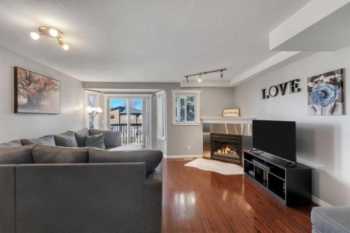 201-215 17 Avenue Ne, Calgary, AB - Indoor Photo Showing Living Room With Fireplace