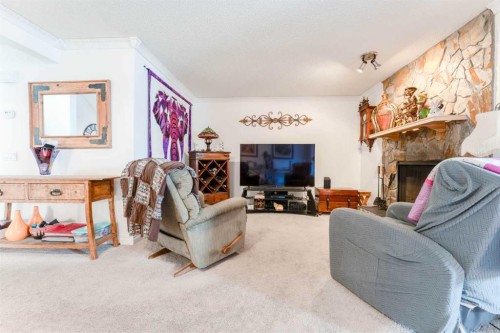 320 Midpark Gardens Se, Calgary, AB - Indoor Photo Showing Living Room With Fireplace