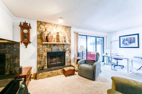 320 Midpark Gardens Se, Calgary, AB - Indoor Photo Showing Living Room With Fireplace