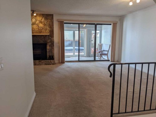 320 Midpark Gardens Se, Calgary, AB - Indoor Photo Showing Other Room With Fireplace