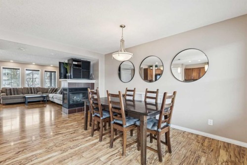77 New Brighton Heights Se, Calgary, AB - Indoor Photo Showing Dining Room With Fireplace