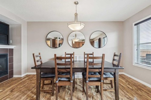 77 New Brighton Heights Se, Calgary, AB - Indoor Photo Showing Dining Room With Fireplace