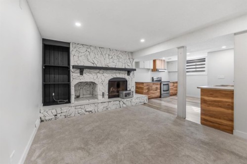 259 Manora Crescent Ne, Calgary, AB - Indoor Photo Showing Living Room With Fireplace