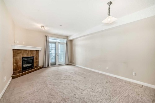 206-1005B Westmount Drive, Strathmore, AB - Indoor With Fireplace