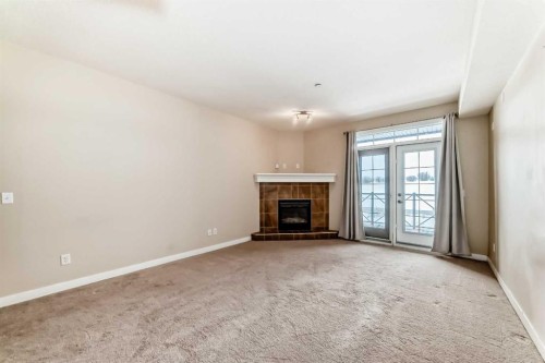 206-1005B Westmount Drive, Strathmore, AB - Indoor Photo Showing Living Room With Fireplace