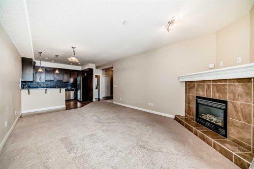 206-1005B Westmount Drive, Strathmore, AB - Indoor Photo Showing Living Room With Fireplace
