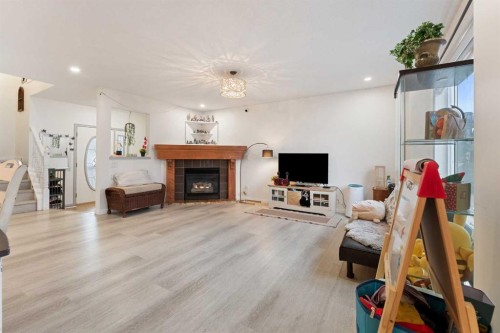 140 Fairways Drive Nw, Airdrie, AB - Indoor Photo Showing Living Room With Fireplace