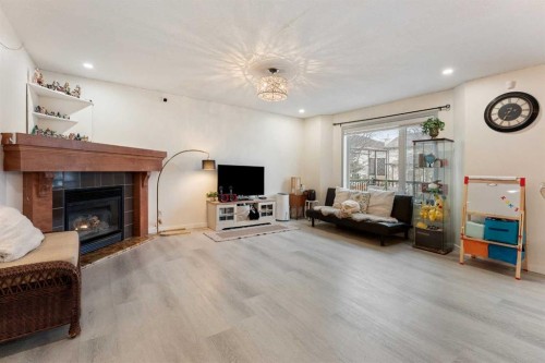 140 Fairways Drive Nw, Airdrie, AB - Indoor Photo Showing Living Room With Fireplace