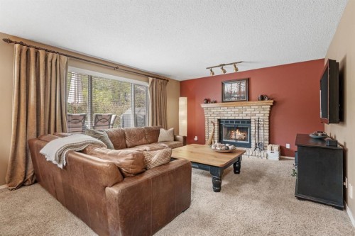 212 Sirocco Place Sw, Calgary, AB - Indoor Photo Showing Living Room With Fireplace
