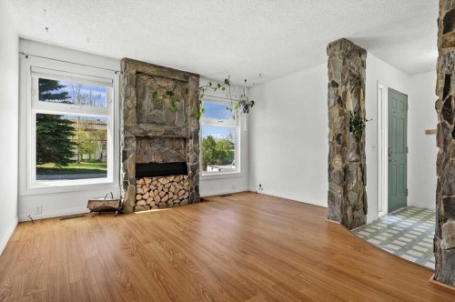 96 Jensen Crescent Ne, Airdrie, AB - Indoor Photo Showing Living Room With Fireplace