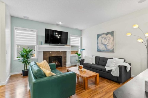1303 New Brighton Park Se, Calgary, AB - Indoor Photo Showing Living Room With Fireplace