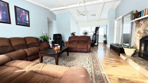 264049 Range Rd 41 Range, Cochrane, AB - Indoor Photo Showing Living Room With Fireplace