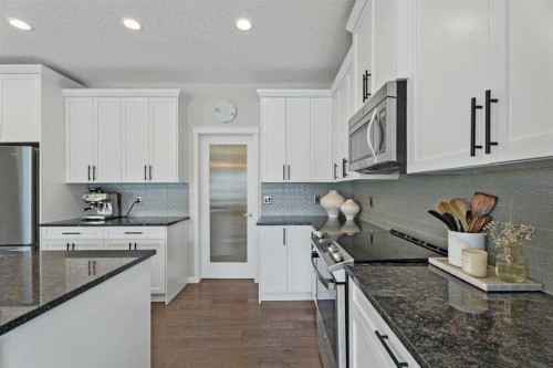 11 Mount Rae Heights, Okotoks, AB - Indoor Photo Showing Kitchen With Stainless Steel Kitchen With Upgraded Kitchen