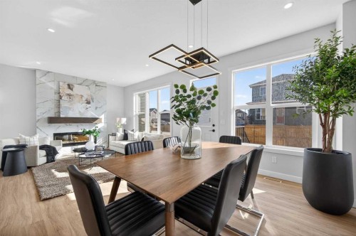 473 Lewiston Landing Ne, Calgary, AB - Indoor Photo Showing Dining Room With Fireplace